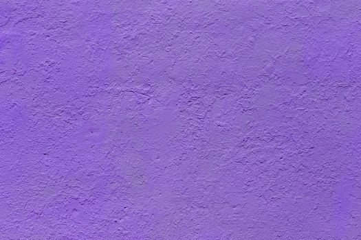 background and texture of flat thick painted matte purple surface under direct sunlight - new paint over fragments of old peeled one