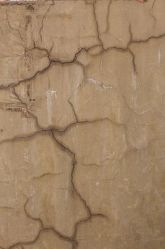 gray dirty cracked plaster wall - flat texture and full frame background.