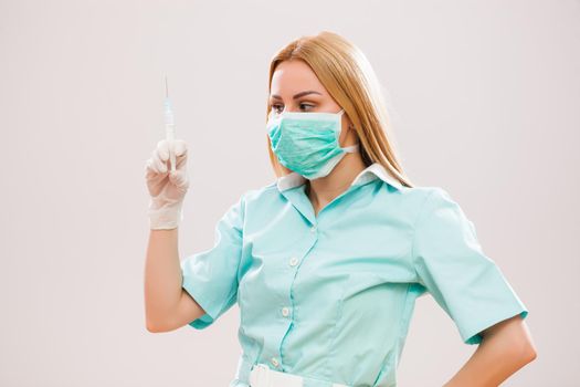 Portrait of young nurse who is holding syringe.