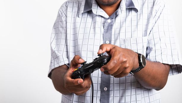 Asian happy portrait young black man funny use hand playing video game pad joystick controller, studio shot isolated on white background