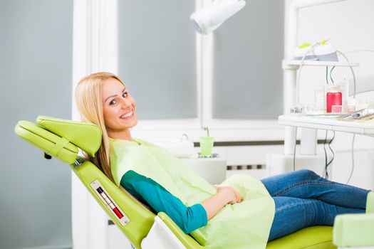 Happy young woman at dentist.