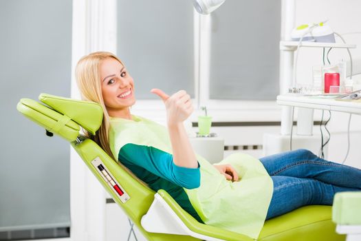 Happy young woman at dentist.