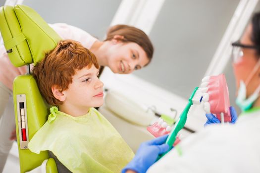 Dentist is teaching children about braces.