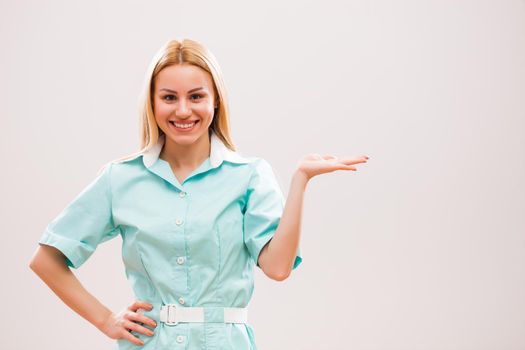 Portrait of young nurse who is holding your text or product.