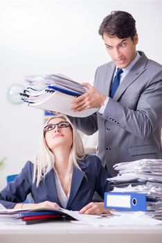 Boss bringing additional work to his assistant secretary