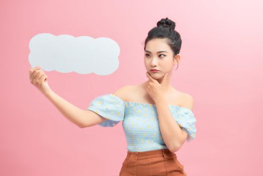 Beautiful woman holding speech bubble in form of cloud with copy space for text. 