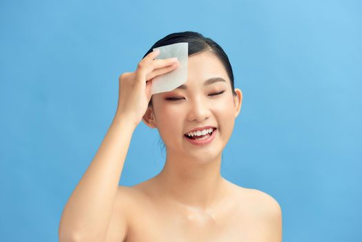 Skin Care. Woman Removing Oil From Face Using Blotting Papers.