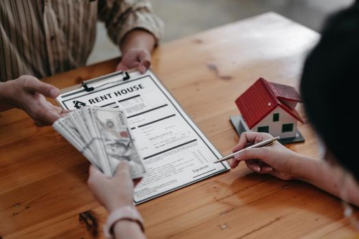 A woman putting signature on document contract, real estate purchase, success business contract deals with rental represent.