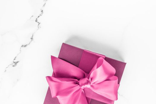 Birthday, wedding and girly branding concept - Pink gift box with silk bow on marble background, girl baby shower present and glamour fashion gift for luxury beauty brand, holiday flatlay art design