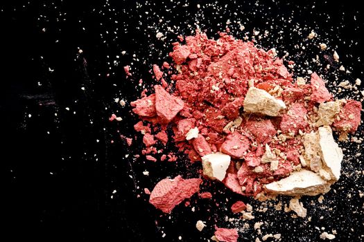 Crushed cosmetics, mineral organic eyeshadow, blush and cosmetic powder isolated on black background, makeup and beauty banner, flatlay design.