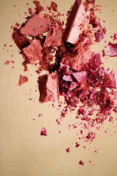 Crushed cosmetics, mineral organic eyeshadow, blush and cosmetic powder isolated on golden background, makeup and beauty banner, flatlay design.