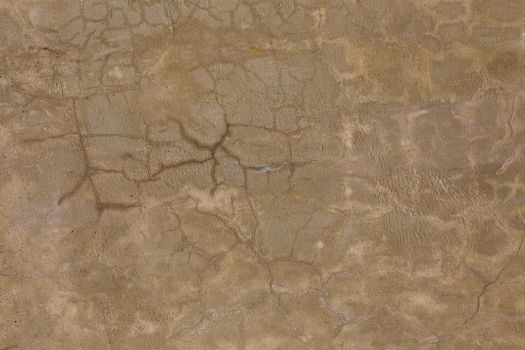 gray dirty cracked plaster wall - flat texture and full frame background.