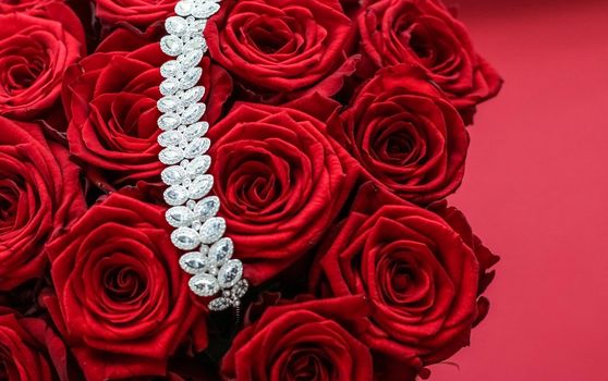 Gemstone jewellery, wedding fashion and luxe shopping concept - Luxury diamond bracelet and bouquet of red roses, jewelry love gift on Valentines Day and romantic holidays present