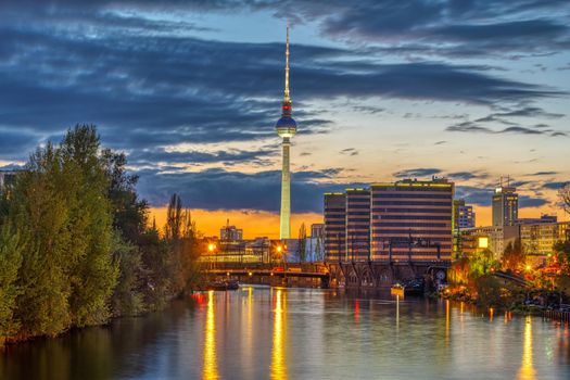 The skyline of Berlin with the famous TV Tower and the river Spree at twilight