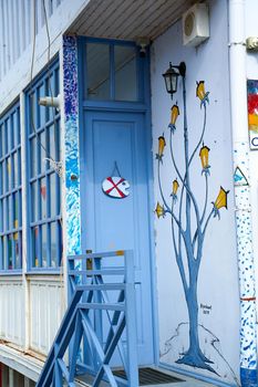 The architecture of the old part of Tbilisi. Narrow door to the wooden veranda of the local bar.