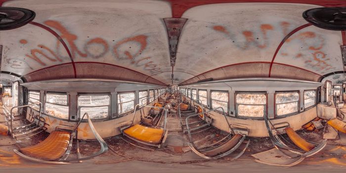 Spherical panoramic photograph of the inside of an old and vandalised train carriage