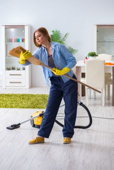 Young woman cleaning floor at home doing chores