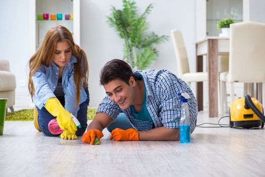 Young family cleaning the house