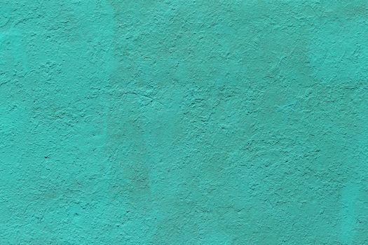 background and texture of flat thick painted matte turquoise surface under direct sunlight - new paint over fragments of old peeled one