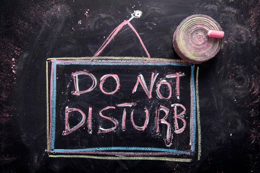 Graphic representation of the word, do not disturb, written with chalk on blackboard