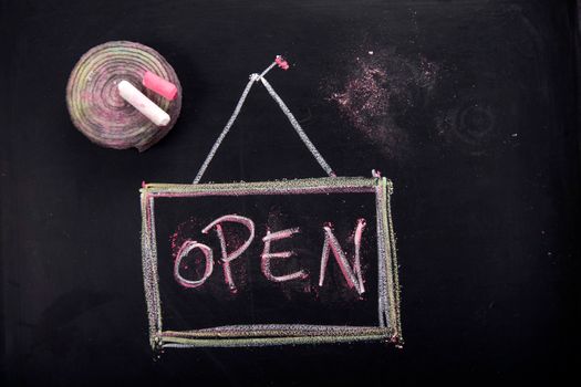 Graphic representation of the word, open, with chalk on blackboard
