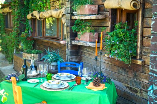 Set table outdoors in rustic setting in summer