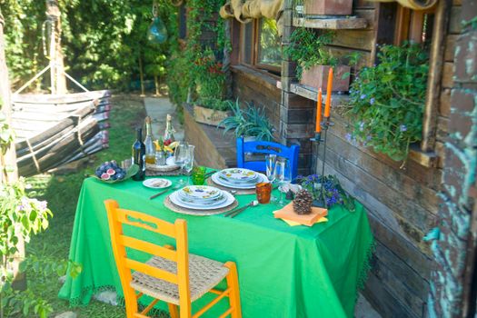 Set table outdoors in rustic setting in summer