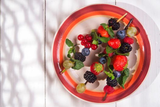 Presentation set of skewers of berries, summer dish