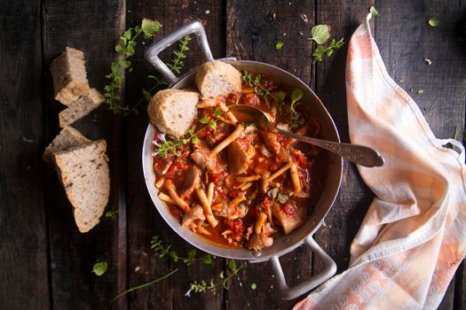 Presentation of a dish with mushrooms pioppini stewed with tomatoes