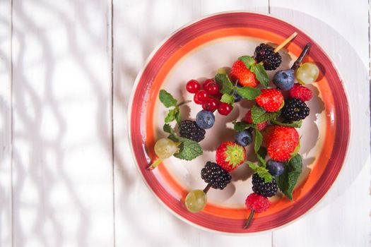 Presentation set of skewers of berries, summer dish