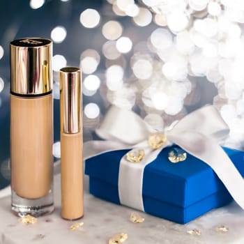 Cosmetic branding, Christmas glitter and girly blog concept - Holiday make-up foundation base, concealer and blue gift box, luxury cosmetics present and blank label products for beauty brand design