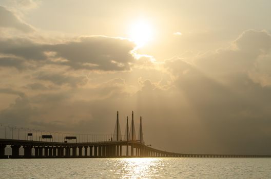 Penang second bridge with golden cloud and sunray in morning.