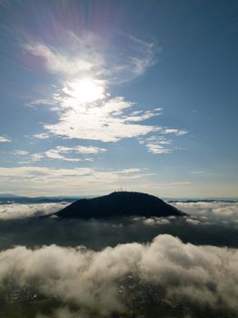 Aerial vertical BM hill covered by sea cloud.