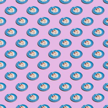 Seamless pattern from blue plates with cottage cheese on a pink background. For printing posters on fabric.