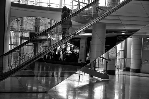 Solitary person waking down a modern staircase.