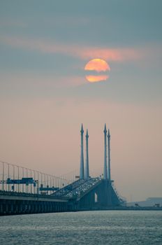 Egg yolk sunrise over cloud at Penang Bridge.