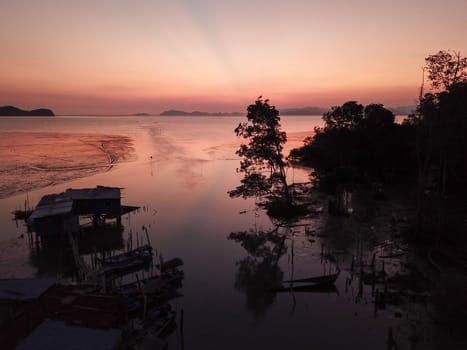 Malays fishing village in sunset.