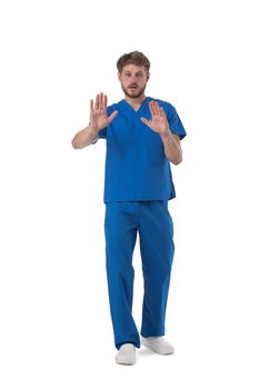 Young male medical nurse healthcare worker showing stop sign isolated on white background full length studio portrait