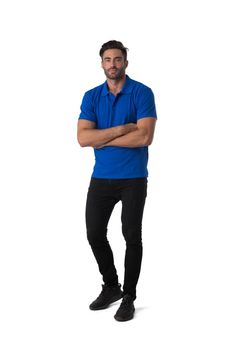 Full length casual portrait of handsome tall young man standing with arms folded isolated on white background