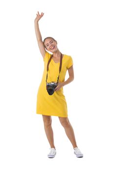 Young beautiful photographer girl in yellow dress with camera isolated on white background