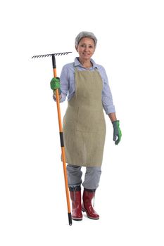 Gardening. Mature woman gardener worker with rake isolated on white background, full length portrait