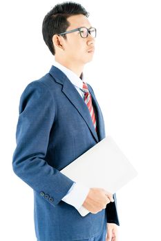 Young asian businessman portrait in suit and wear glasses holding a laptop over white background