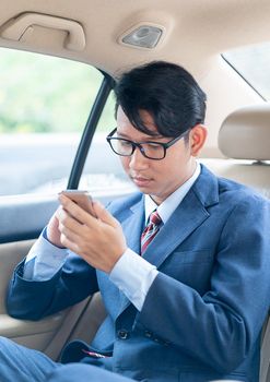 Young asian business men portrait in suit  talking on the phone in car