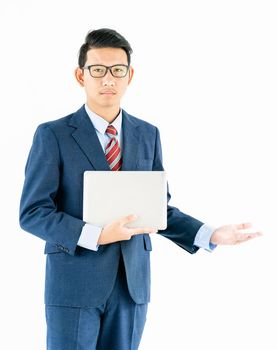 Young asian businessman portrait in suit and wear glasses holding a laptop over white background