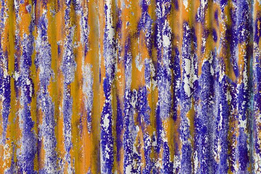 colorful motley peeled off orange nad blue paint layers on corrugated zinc coated steel sheet - full frame background and texture
