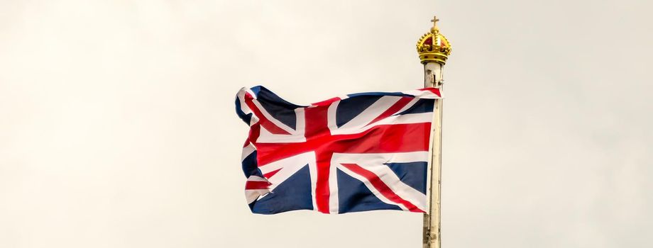 Union Jack Flag flying on a cloudy day in London, UK