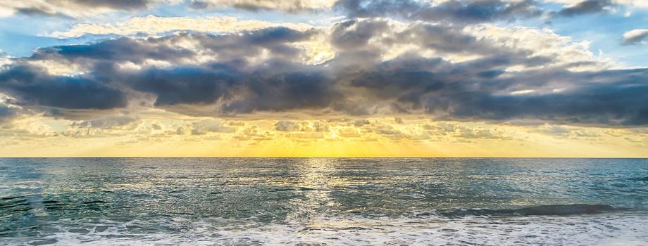 Sunset on the mediterranean sea with a scenic cloudy sky, Italy