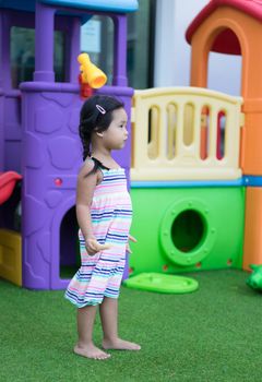 little girl holding a snack in the playground