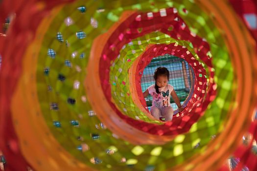 Asian little girl enjoys playing in a children playground