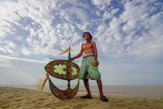 Kota Bahru, Kelantan/Malaysia - Jul 15 2017: An unidentified man pose with his hand made moon kite.